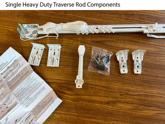 Heavy duty white traverse rod set with brackets, draw cord and hardware laid out — center open pinch pleat rod kit