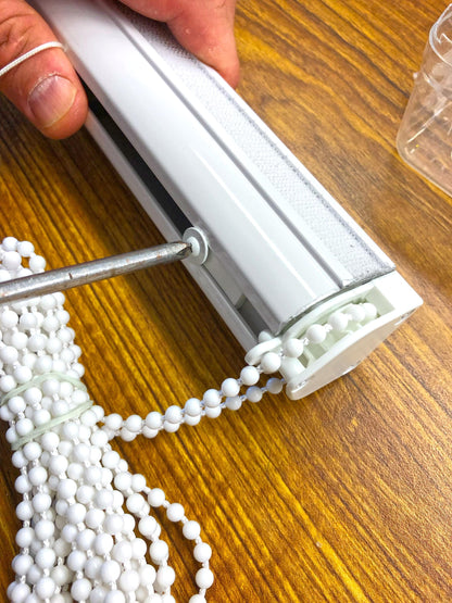 Chain Roman shade mechanism only: hand holding white custom width track with clutch and continuous loop bead chain, DIY Roman blind hardware handmade in Toronto