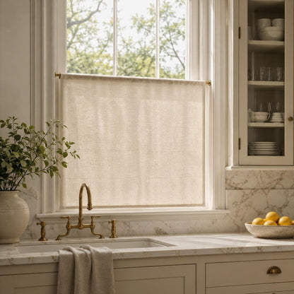 Flat tailored faux linen cafe curtain on a slim rod in a bright kitchen with marble counters