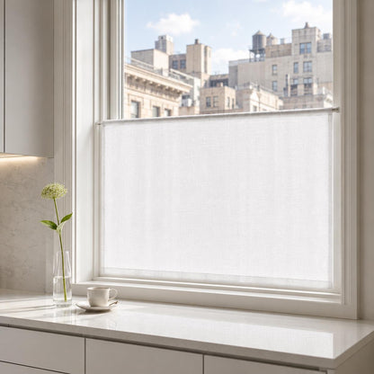 Snow white faux linen cafe curtain on the lower sash of a tall city window