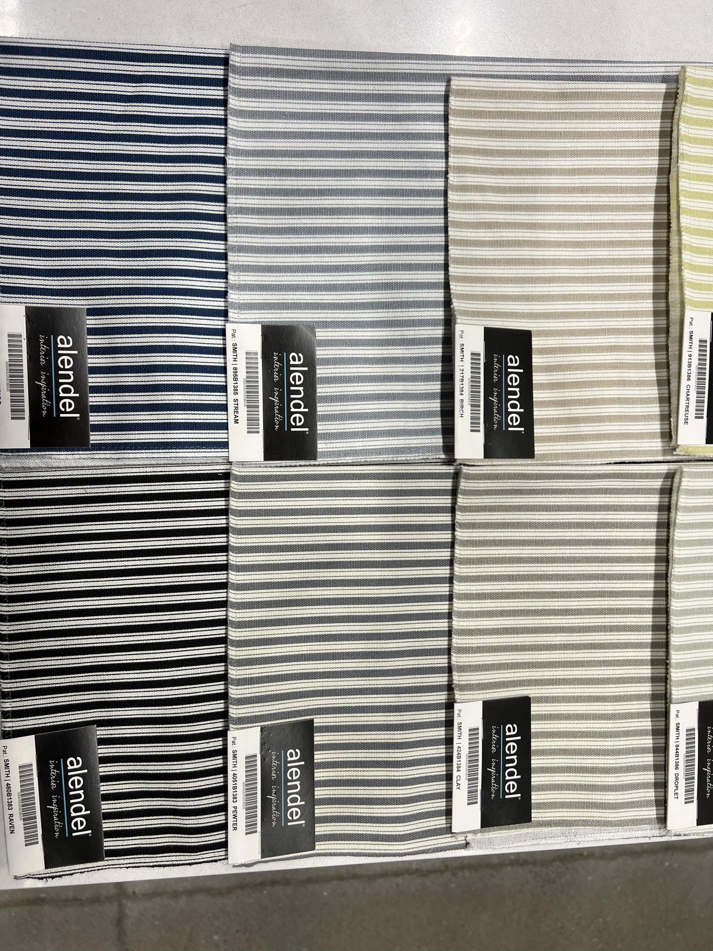 Ticking stripe cotton swatches in navy, charcoal and cream showing available curtain colours.