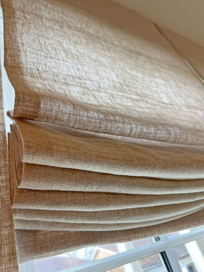 Close-up of the flat folds and coarse weave on a Zoe Italian linen Roman shade