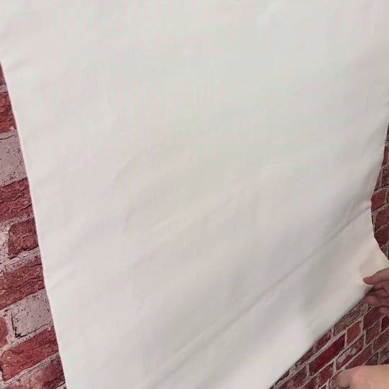 Irish linen relaxed Roman shade raising and lowering, showing the soft fold and light