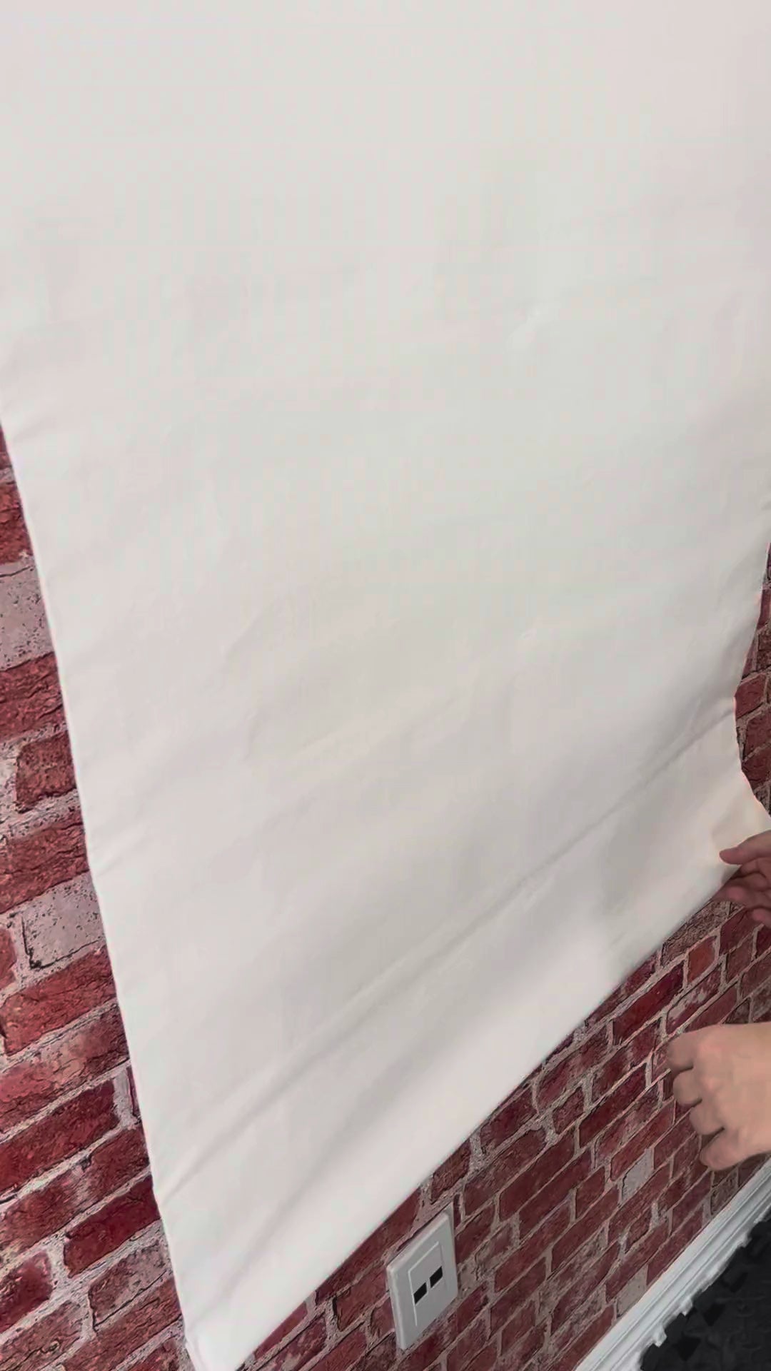 Irish linen relaxed Roman shade raising and lowering, showing the soft fold and light