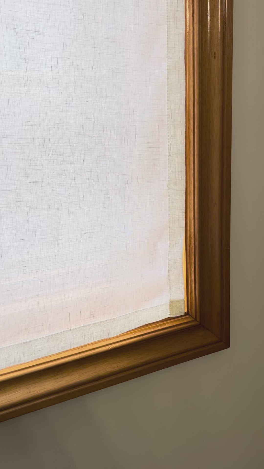 Video: sheer linen cafe curtain fitted inside a wood-framed window, daylight glowing through the open weave