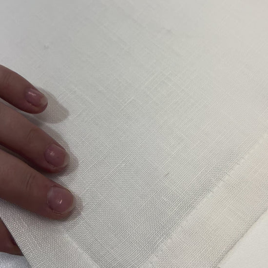 Video: hands showing the double-folded hem and clean corner stitching of a sheer linen cafe curtain