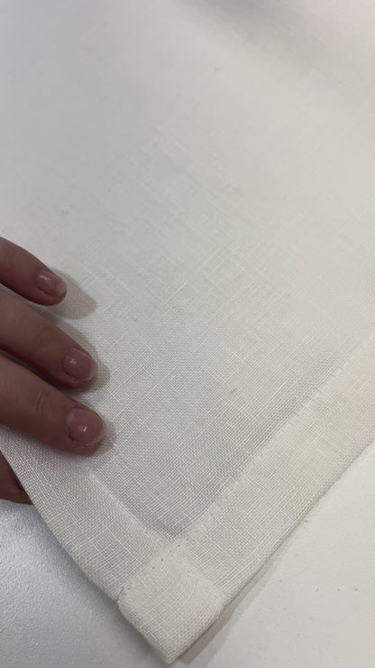 Video: hands showing the double-folded hem and clean corner stitching of a sheer linen cafe curtain