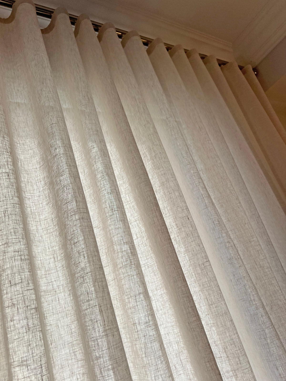 Brent Candle sheer ripple fold drapery seen from below, even S-folds hanging from the track under crown moulding