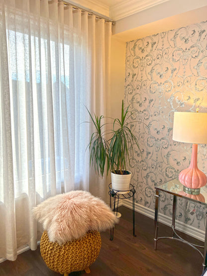 Custom Brent Candle sheer ripple fold drapery over a bedroom window next to damask wallpaper and a pink lamp