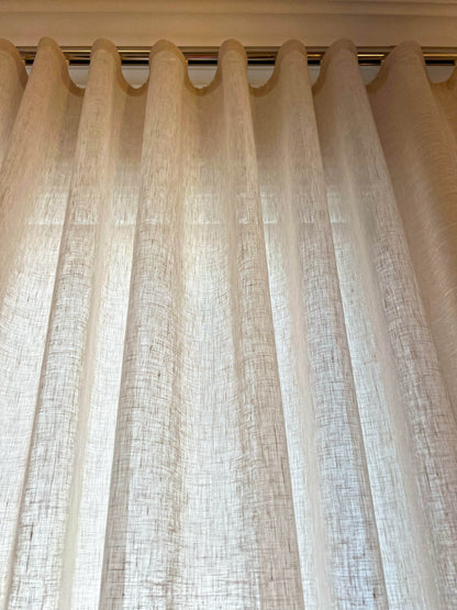 Ripple fold header of a Brent Candle linen-blend sheer, slub weave glowing with daylight behind it