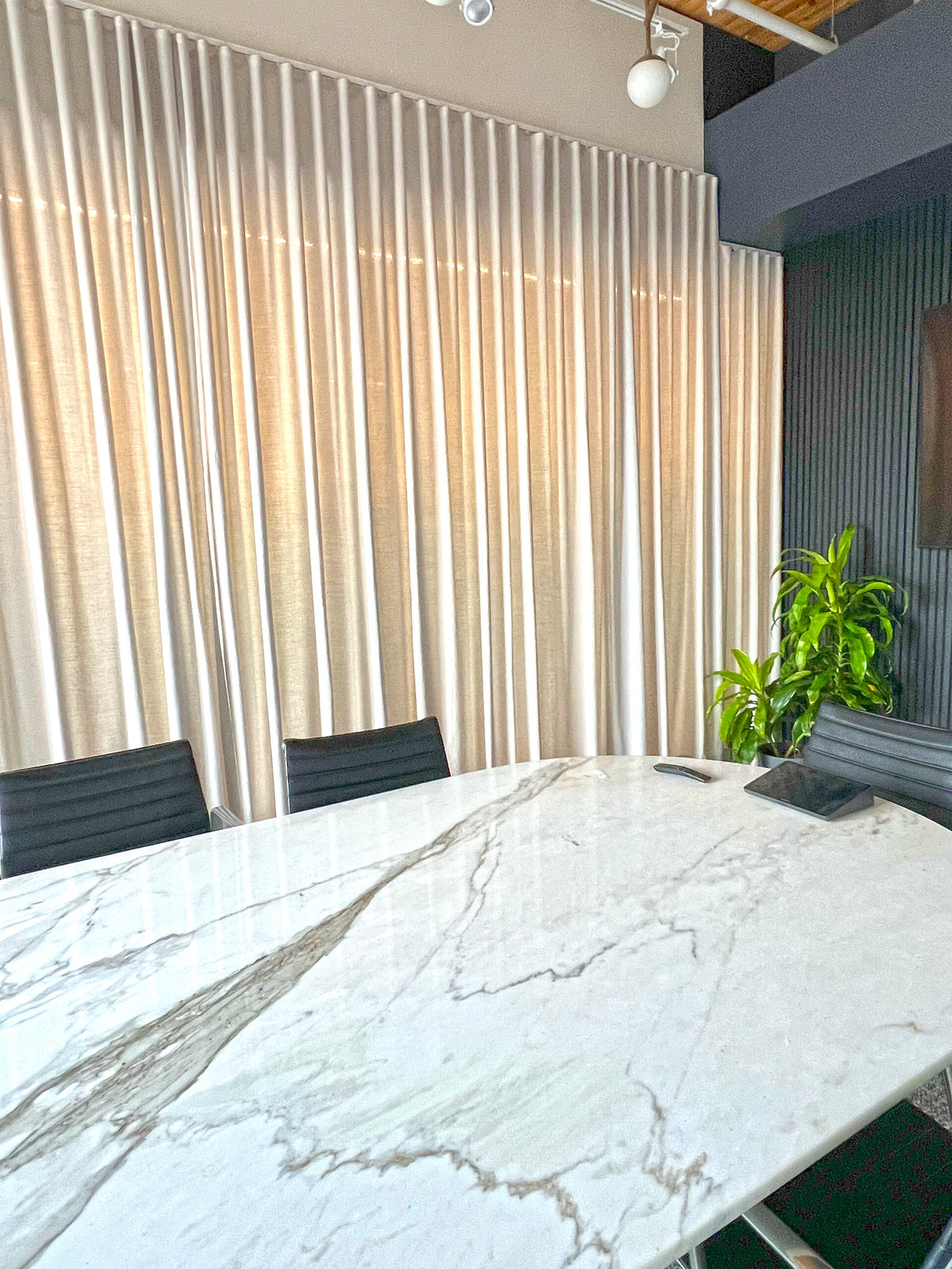 Far Cloud drapery panel with daylight behind it, showing how the opaque weave filters light