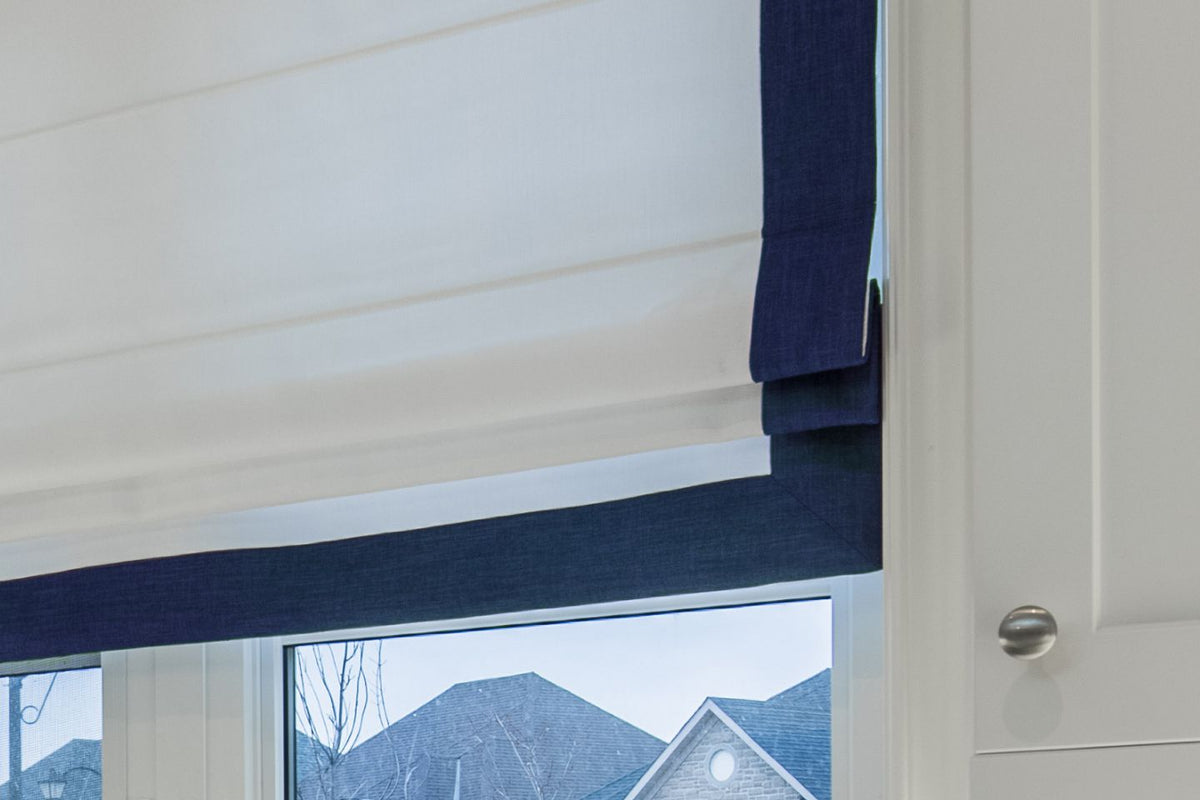 White flat Roman shade with Indigo border