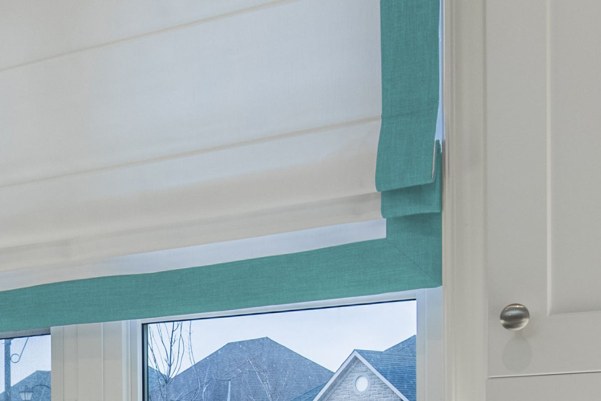 White flat Roman shade with Seafoam border