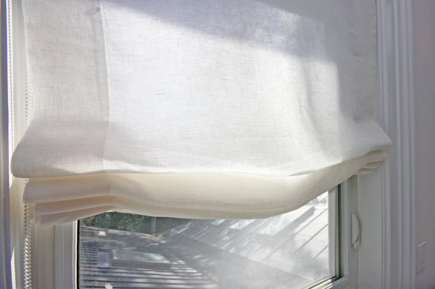 Sheer linen Roman shade in interior